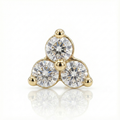 Gold earring with three clear gemstones on a white background