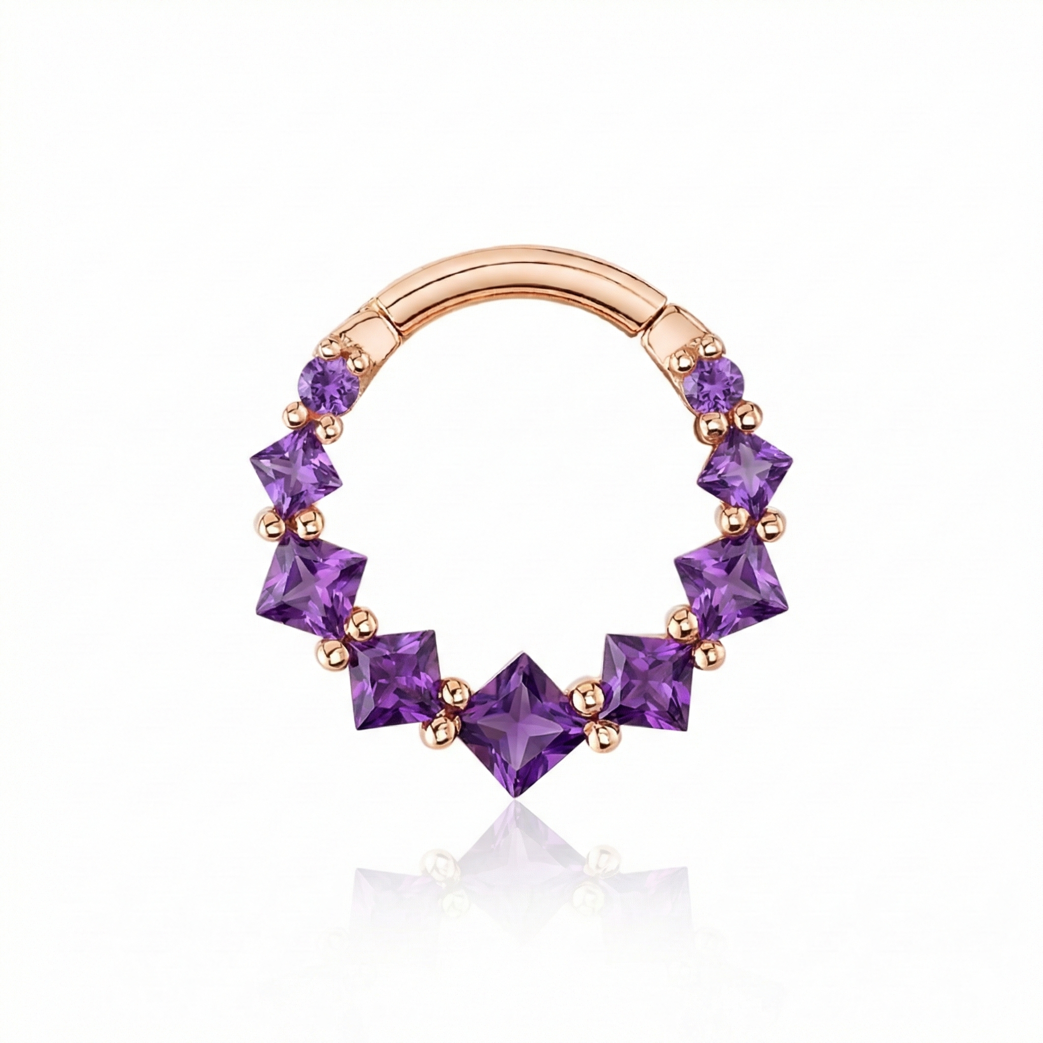Rose gold nose ring with purple gemstones on a white background