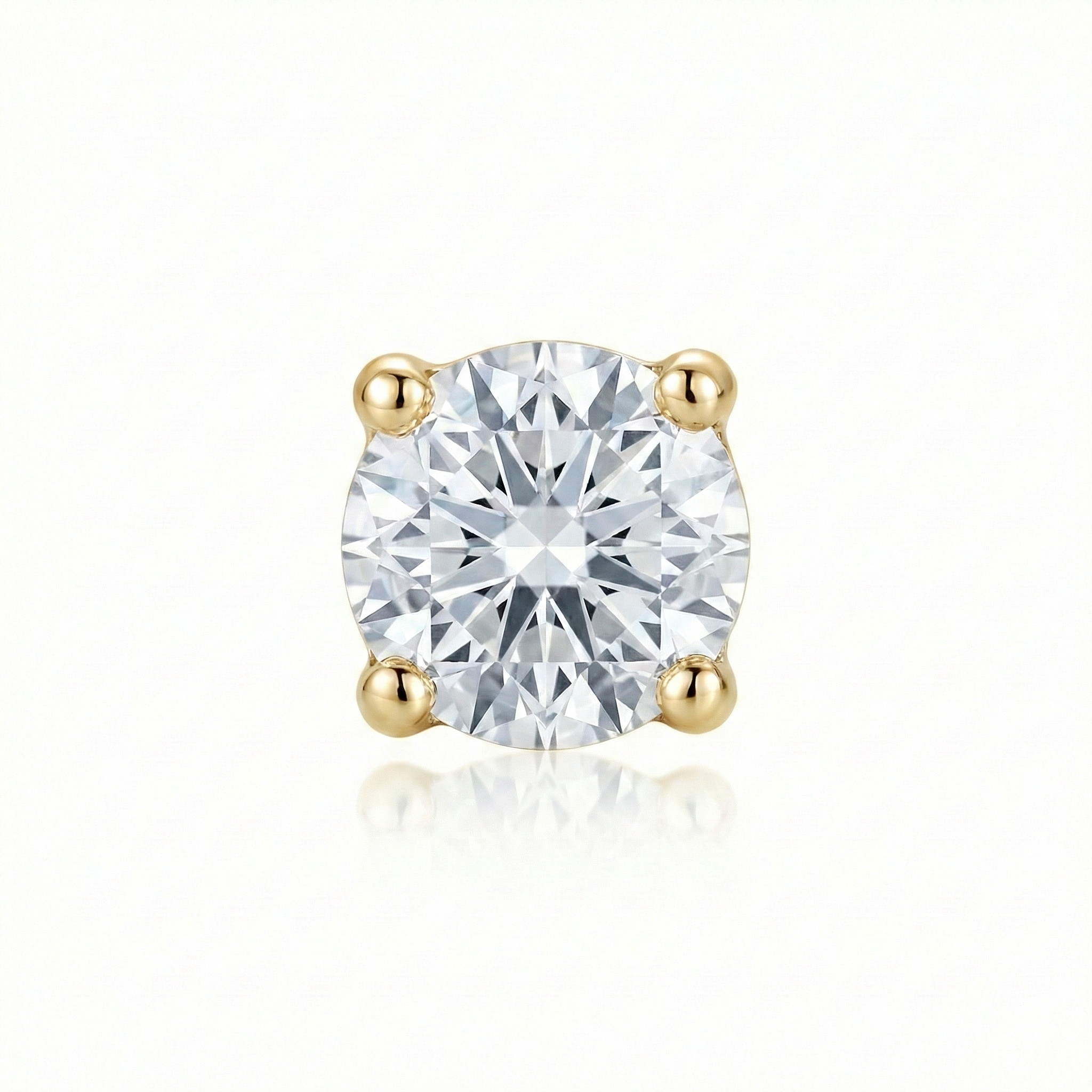 Gold earring with a clear gemstone on a white background
