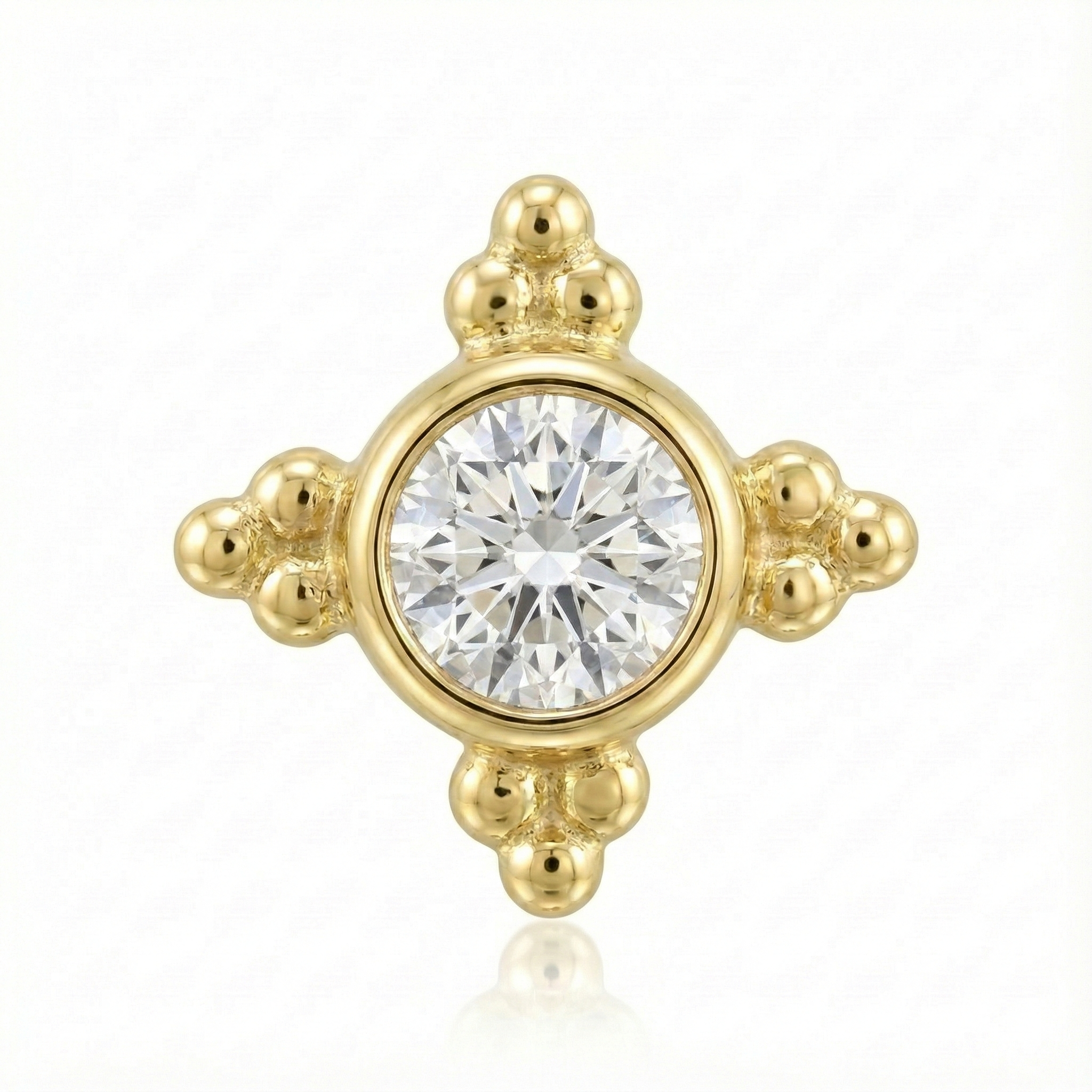 Gold earring with a central diamond on a white background