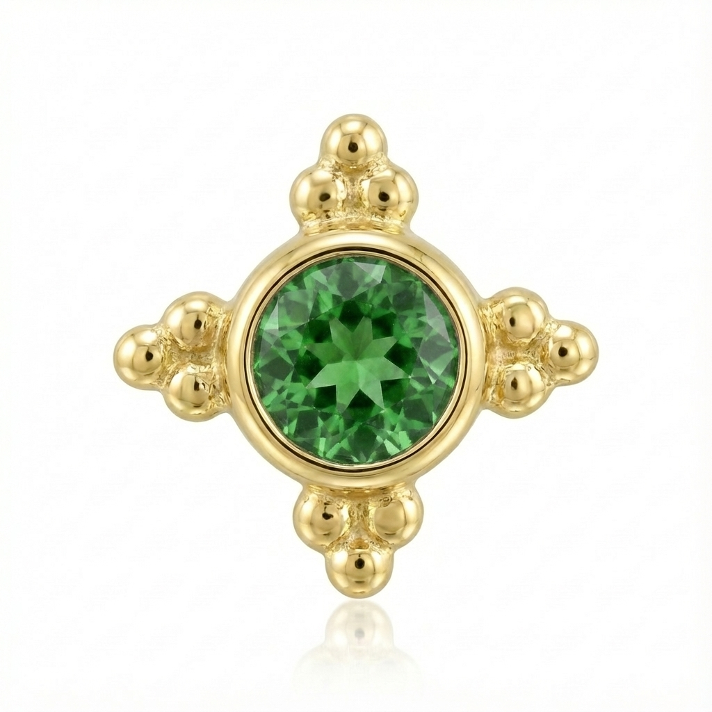 Gold earring with a green gemstone on a white background