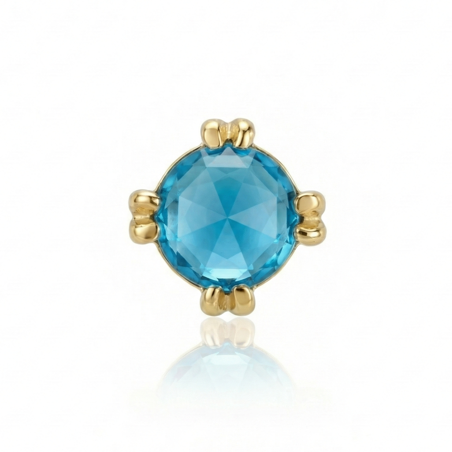 Gold earring with a blue gemstone on a white background