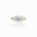 Gold ring with a marquise-shaped diamond on a white background