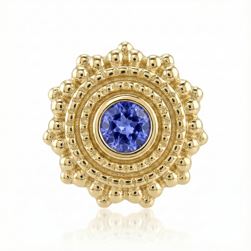 Gold earring with a blue gemstone on a white background