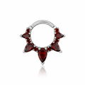 Silver nose ring with red gemstones on a white background