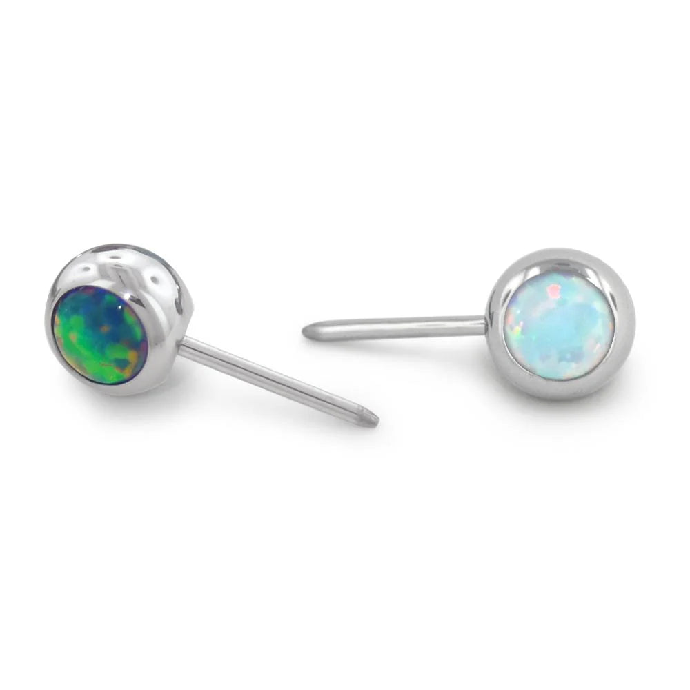 Pair of silver stud earrings with opal stones on a white background
