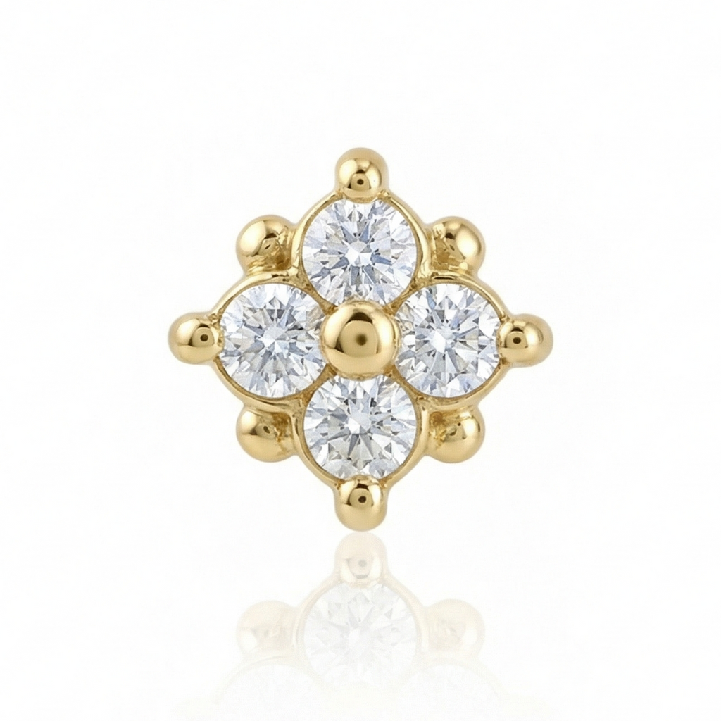 Gold earring with clear gemstones on a white background